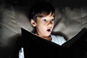 boy is shocked reading book
